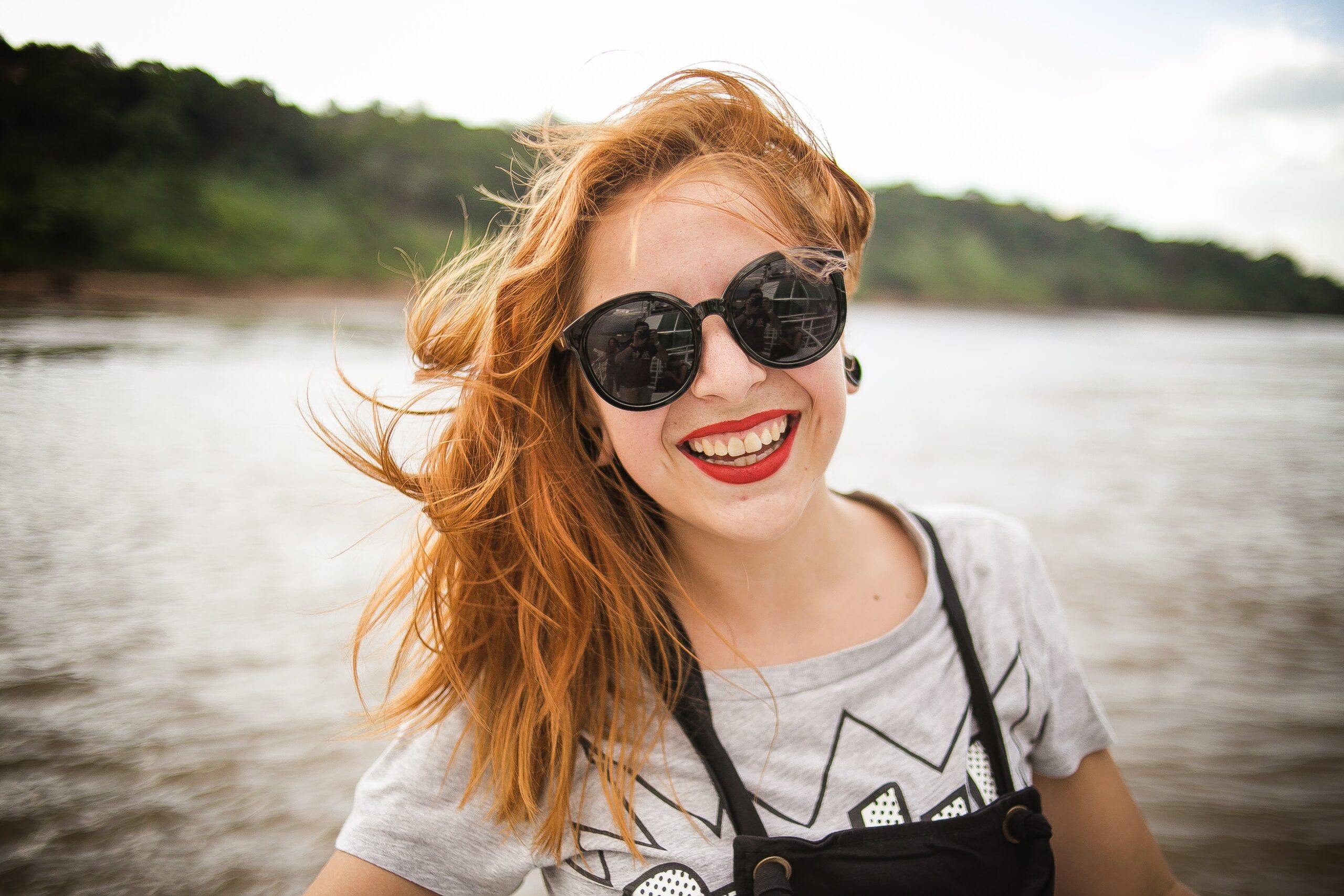 red hair woman by water