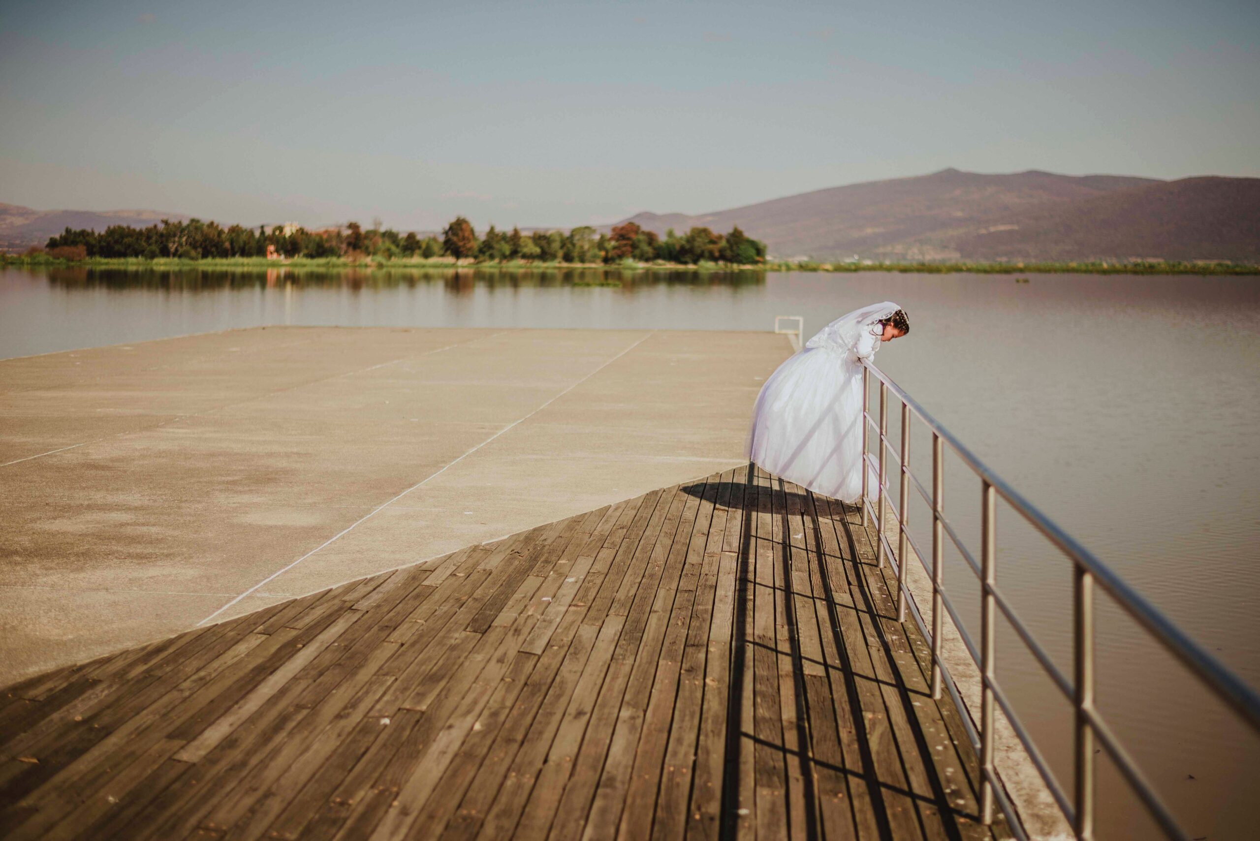 wedding dress woman looking over rail