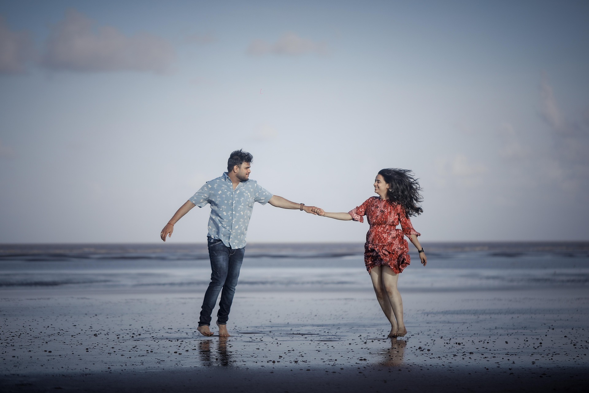 Couple running thru the water