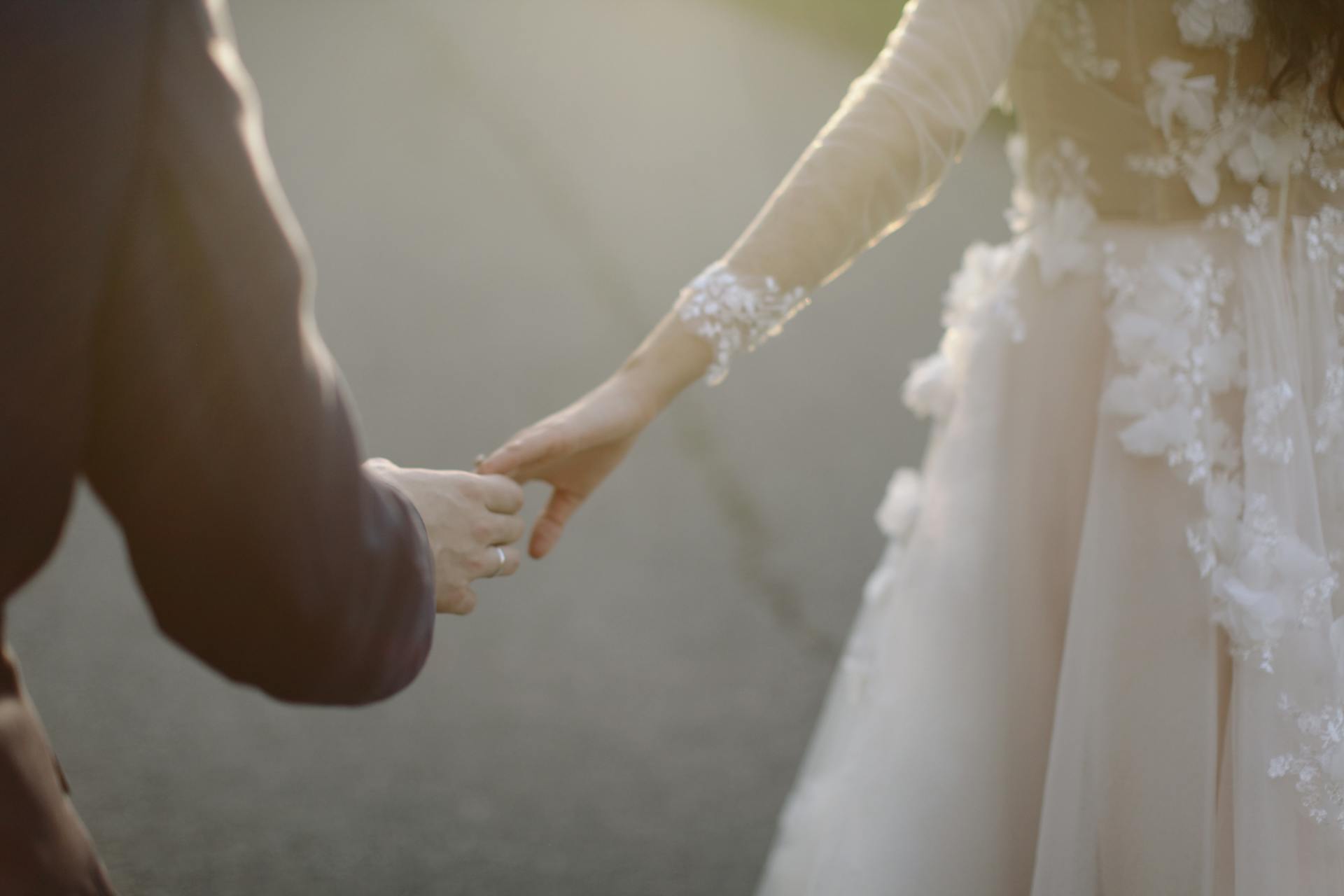 couple holding hands married
