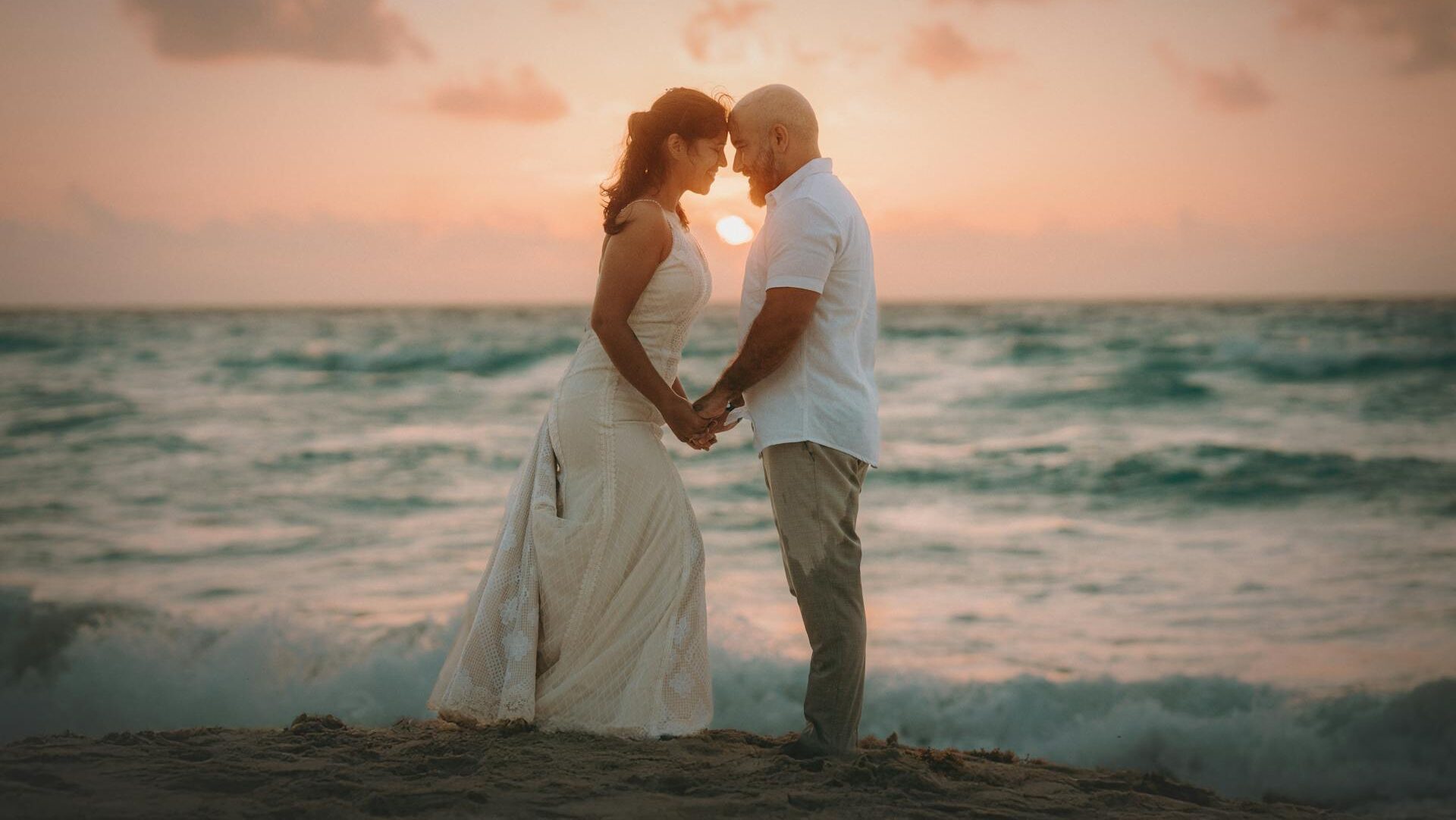 couple by waterfront sand
