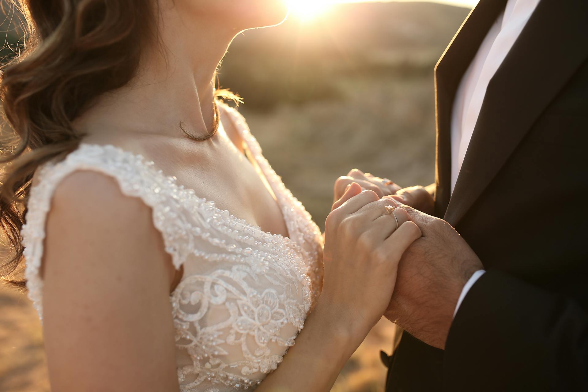 couple holding hands sun