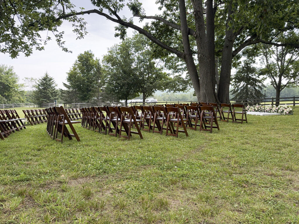 Outdoor wedding ceremony seating under oak trees in the paddock at Glen Oro Farm