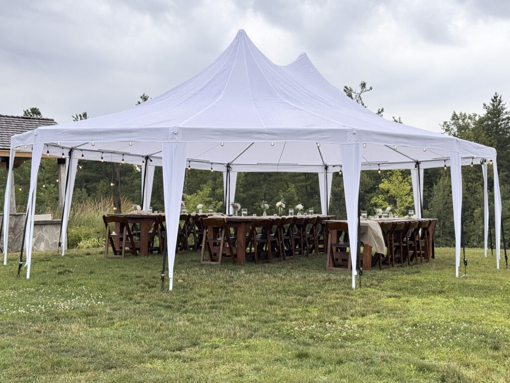A smaller sailcloth tent near the Ranger Cabin at Glen Oro Farm, set for an intimate dinner or cocktail reception